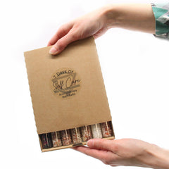 Set of seven AW GIFTS bath salts in small glass vials, ideal for gift packs and relaxing bath experiences.