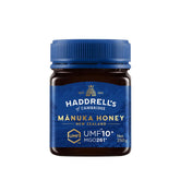 Jar of Herbalistas Haddrells Manuka Honey UMF10+ with MGO83+ in a 250g jar, showing the honey's golden, viscous texture.