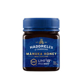 Herbalistas Haddrells Manuka Honey UMF13+ MGO404+ in a 250g jar, showcasing the golden, thick honey with a smooth texture.