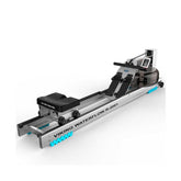 Viking Fitness Waterflow R-2001 Water Rower rowing machine with wooden frame and adjustable resistance, displayed in a home gym setting.