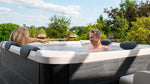 VIKING FITNESS MSpa Oslo Plus outdoor hot tub with seating and control panel, set up in a backyard patio.