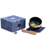 AW Gifts Chakra Singing Bowl for Third Eye, a brass accessory with intricate carvings and a wooden mallet for meditation.