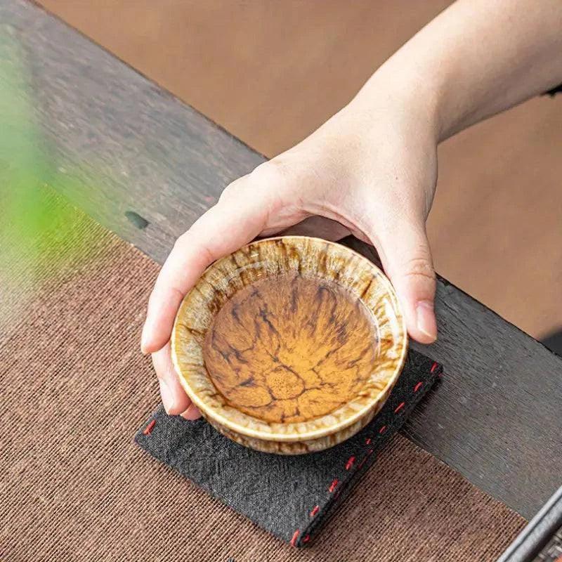 Handmade ceramic teacup set for drinking, featuring two cups with intricate patterns, perfect for tea enjoyment.