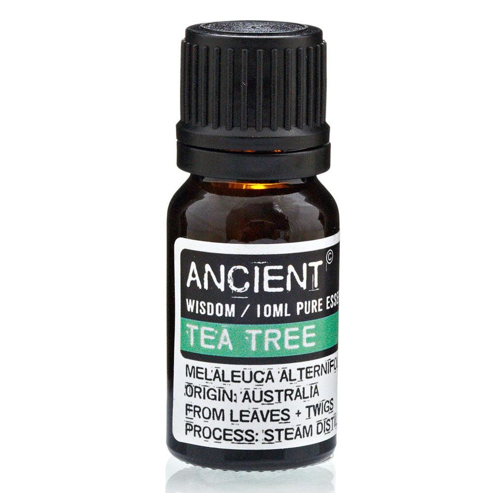 Bottle of AW Gifts Tea Tree Essential Oil for skin care, 10ml, with dropper cap and fresh tea tree leaves in the background.