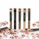 Set of seven AW GIFTS bath salts in vials, arranged in a gift pack for relaxing bath experiences.