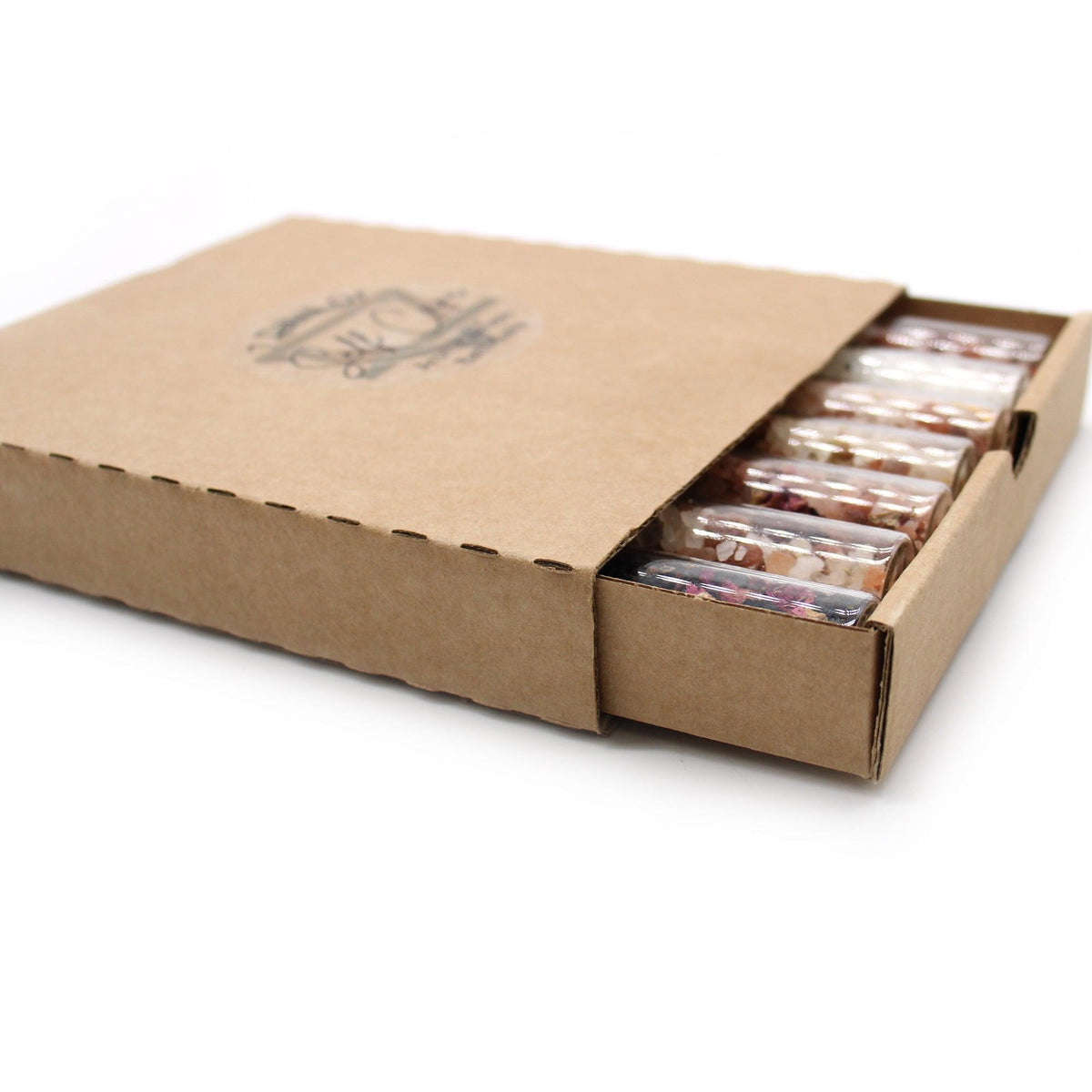 Set of seven AW GIFTS bath salts in glass vials, perfect for gifting, with colorful labels and elegant packaging.