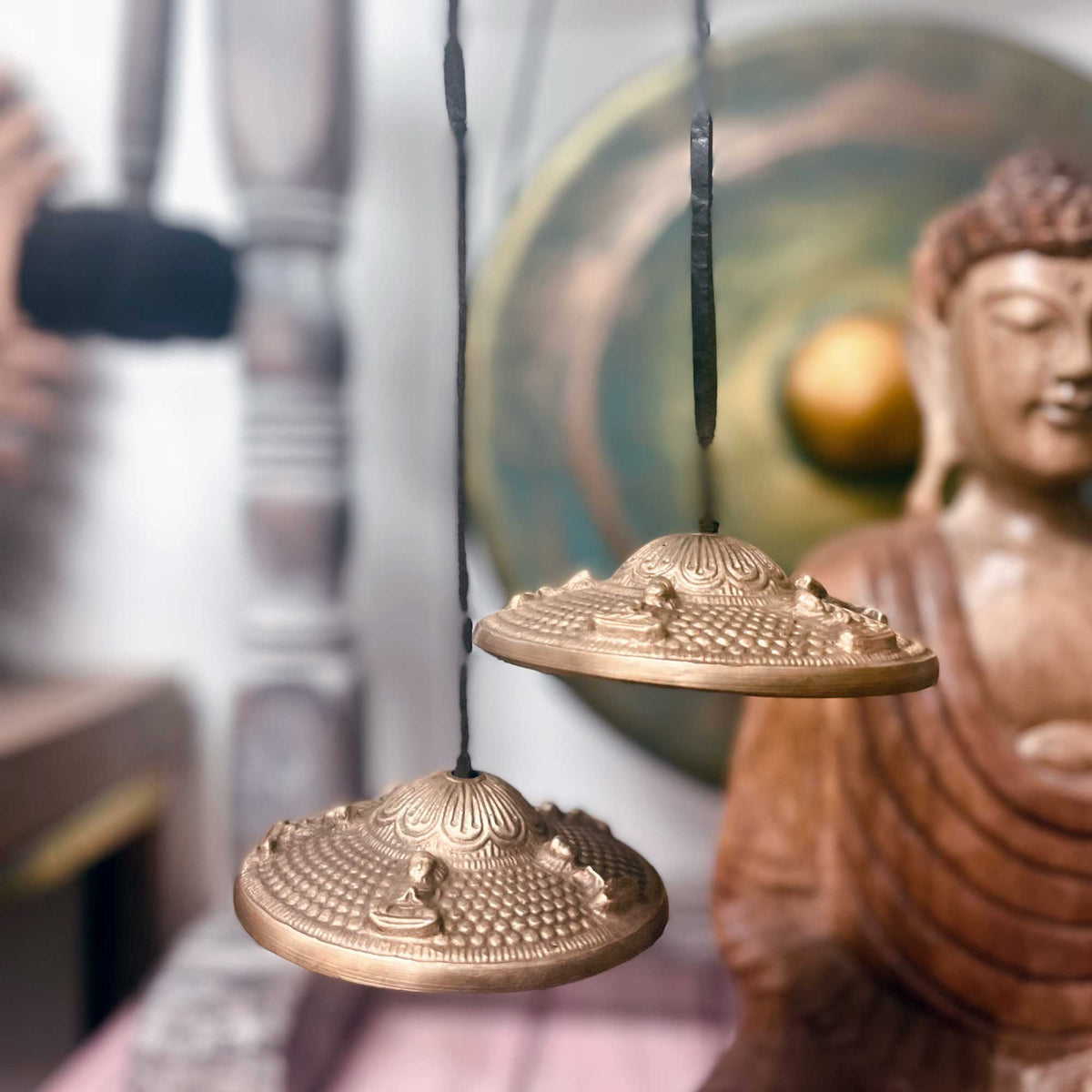 Tibetan Tingsha bell with Five Buddha design, approx 9.5cm, from AW Gifts, showing intricate metal craftsmanship and traditional symbols.
