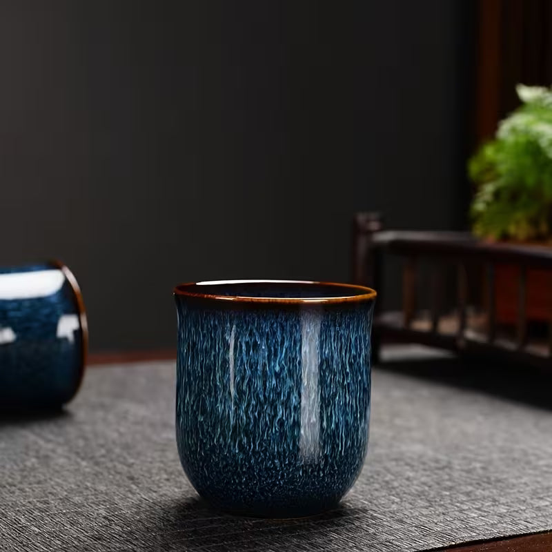 Japanese kiln-glazed porcelain tea set with 6 cups and teapot with filter in dark blue, featuring elegant traditional design.