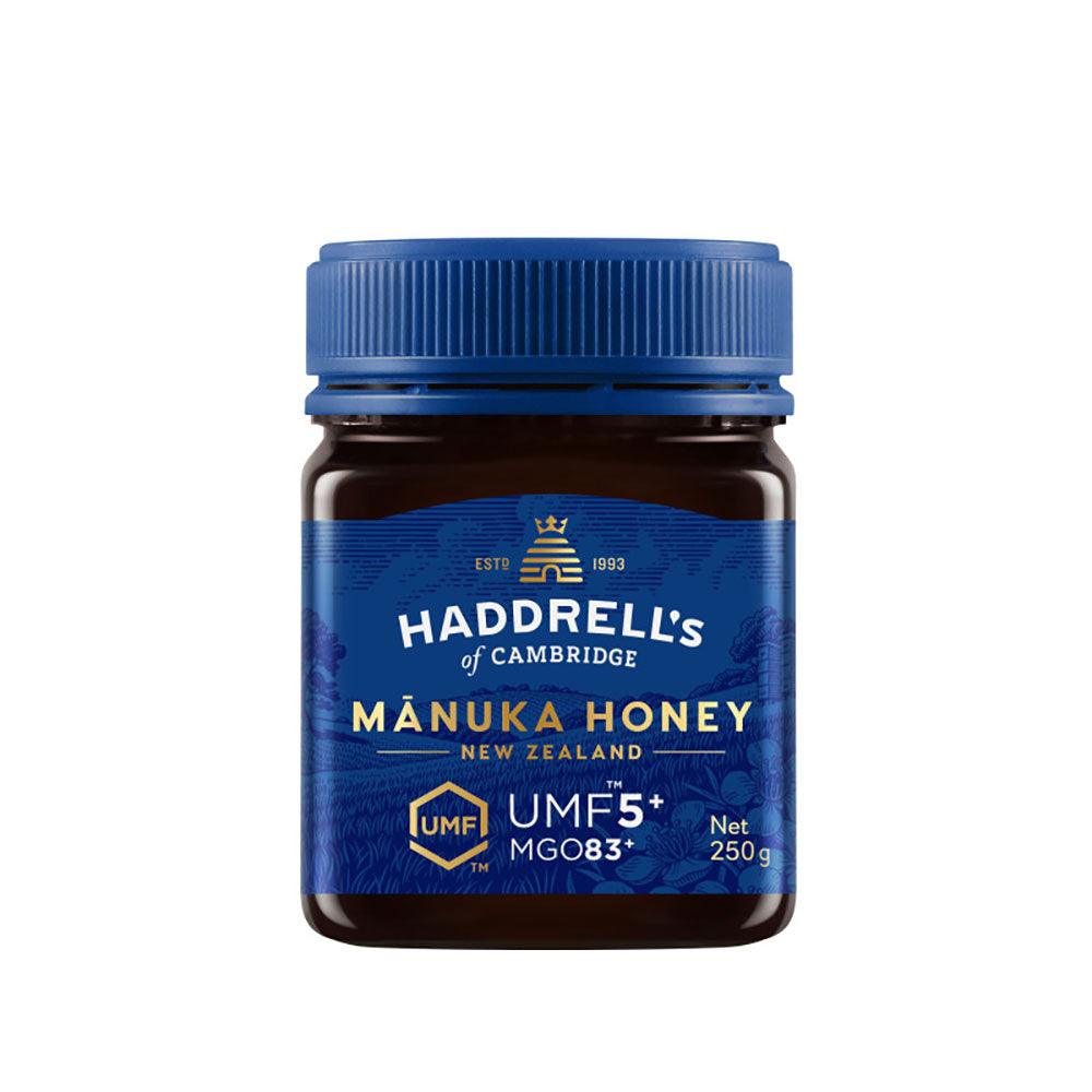 Jar of Herbalistas Haddrells Manuka Honey UMF5+ with MGO83+ in a 250g container, showing the honey's golden, viscous texture.