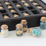 Set of 55 natural gemstone crystal bottles from TEMU, featuring colorful, polished mineral specimens in small glass bottles.