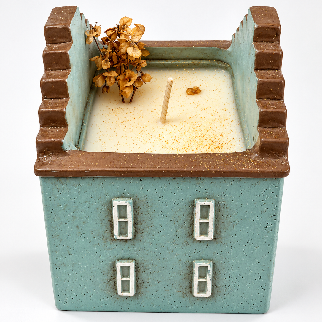 Velarte Little Haven handmade soy wax house candle in wavy blue with intricate design and warm, inviting glow.
