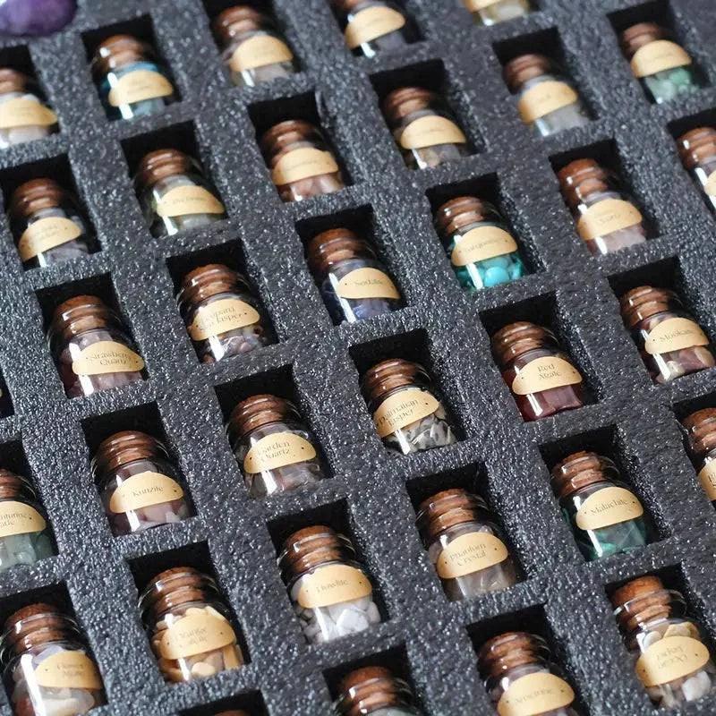 Set of 55 natural crystal gemstone bottles with assorted stones in clear glass, featuring colorful, polished gemstones inside.