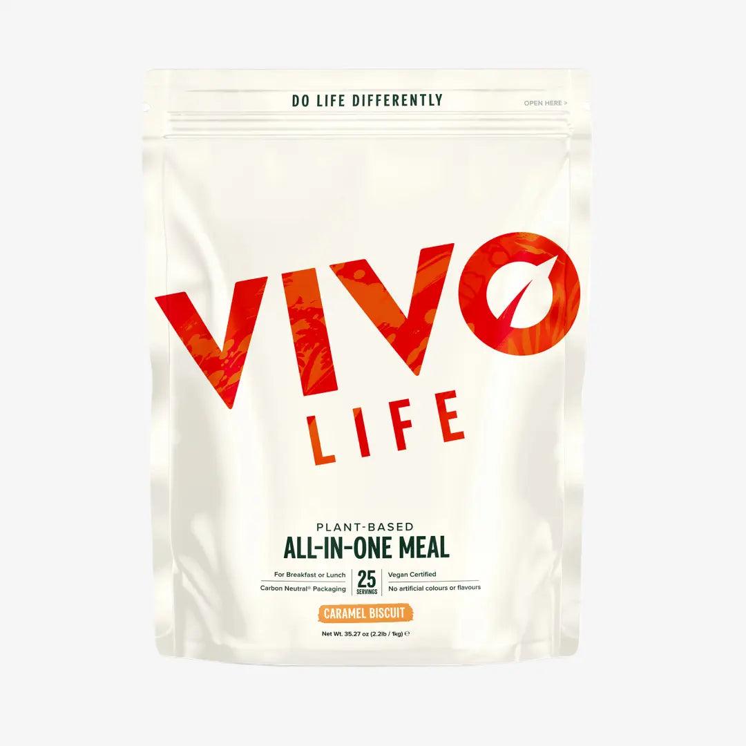 Vivo Life Whole Plant-Based Nutritional Shake supplement in a glass with a scoop of powder and fresh ingredients.