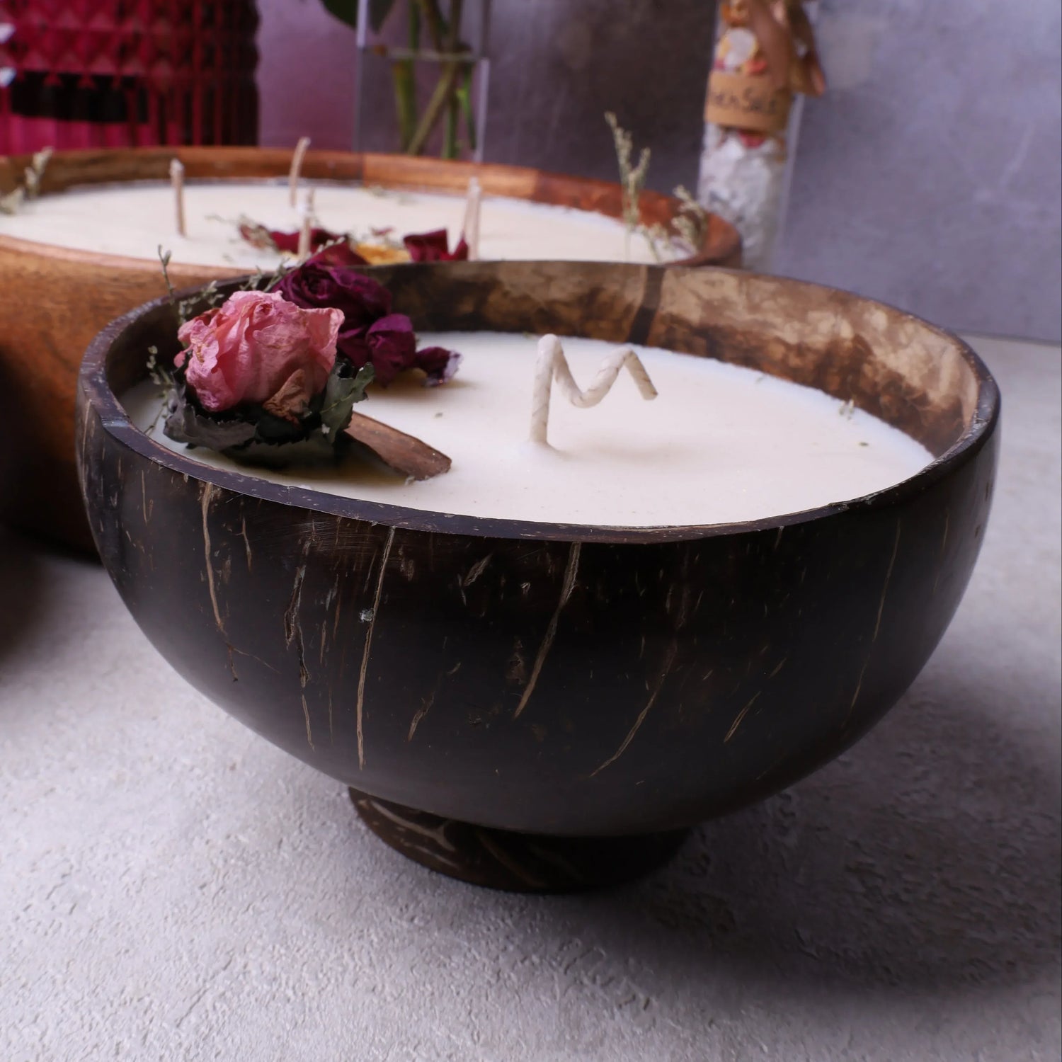 Soy wax candle in a coconut bowl with base, Velarte brand, showcasing a cozy, natural home decor accessory.