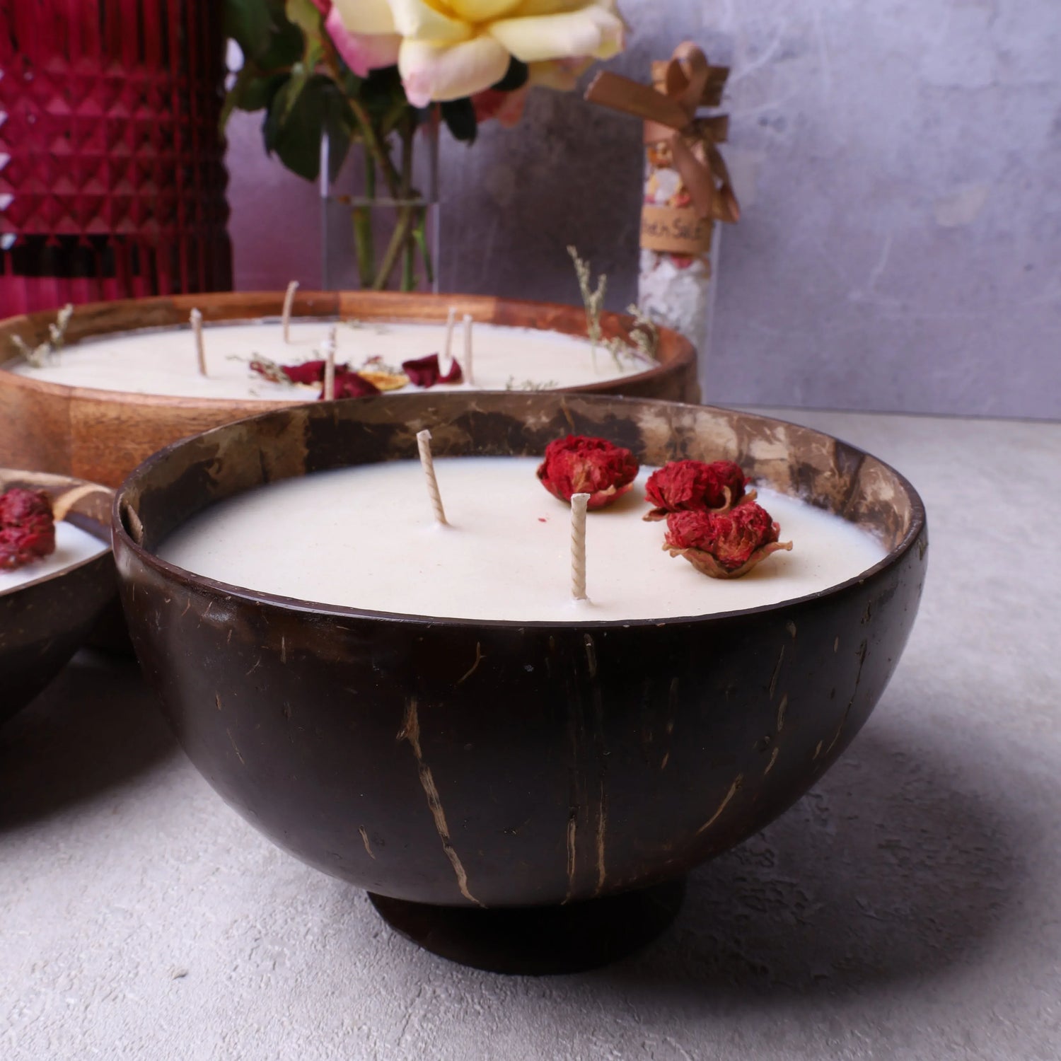 Velarte soy wax candle in a coconut bowl with base, featuring a natural aesthetic and warm, inviting glow.