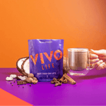 Vivo Life Magic Chaga Chai Latte supplement package featuring a colorful label and a steaming chai latte in a mug.