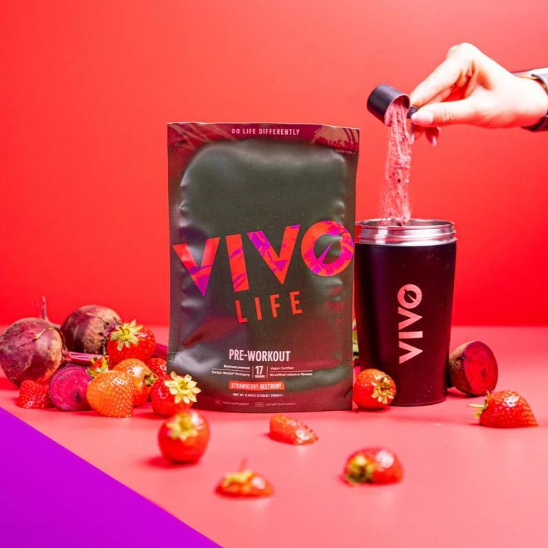 Vivo Life pre workout supplement container with label, showing a healthy lifestyle with fresh ingredients and vibrant colors.
