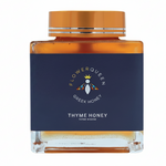 Glass jar of LV Natural Foods Queen Thyme Honey superfood, featuring a label with golden honey and thyme herbs.