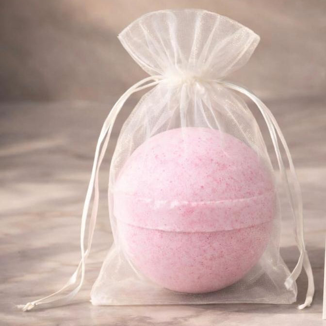 Pink Velarte bath bomb with a smooth round shape and vibrant pink color, perfect for relaxing bath time.