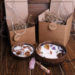 Soy wax candle in a coconut bowl with a unique crystal on top, by Velarte, displayed in a cozy setting.