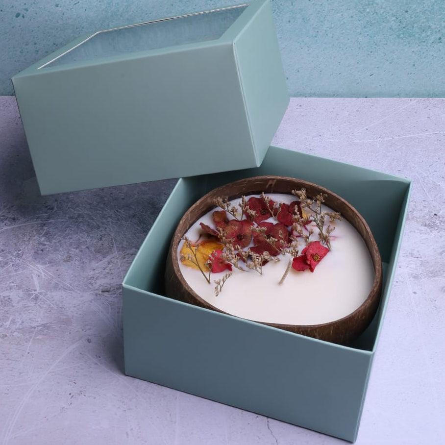 Soy wax candle in a coconut bowl by Velarte, featuring a smooth, white candle with a natural, minimalist design.
