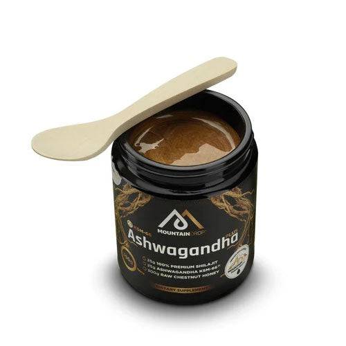 Open jar of Herbalistas MountainDrop Shilajit blend with Ashwagandha and chestnut honey, showing the textured mixture inside.