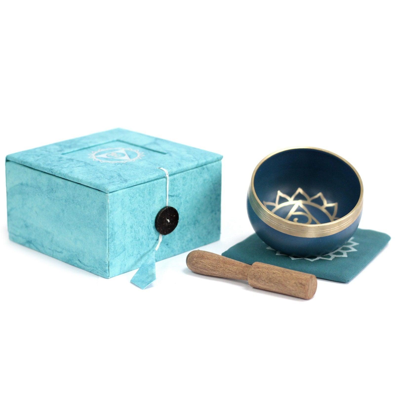 AW Gifts Chakra Singing Bowl for Throat, a spiritual accessory with a wooden striker and vibrant design, used for meditation and sound healing.