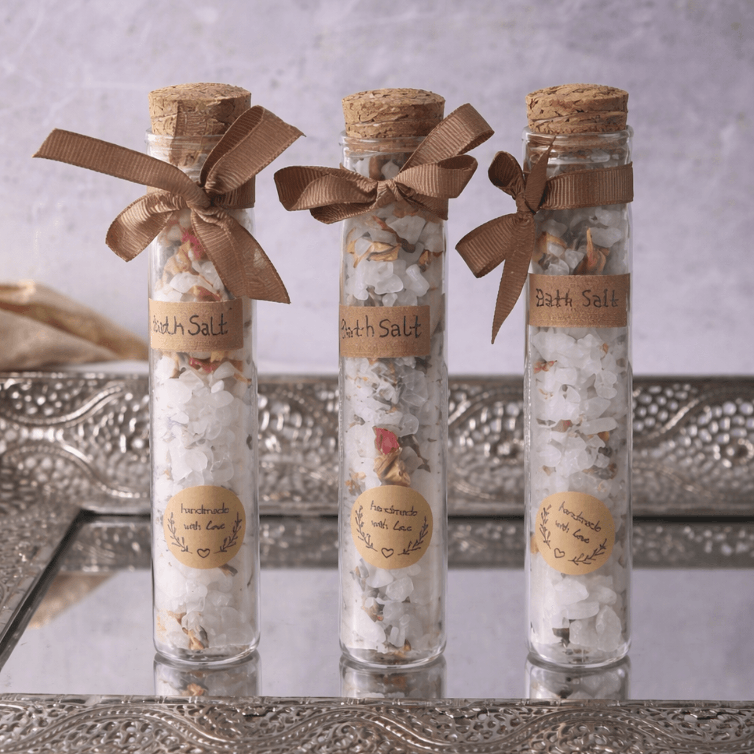 Velarte bath salts in a clear glass tube, containing aromatic white and pink bath salts for relaxing bath experience.