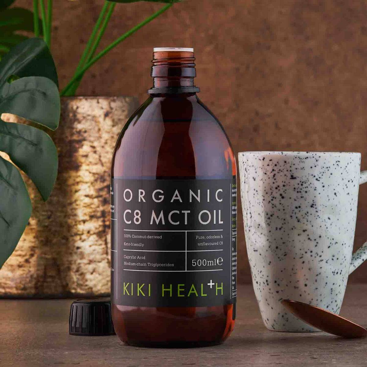 Organic C8 MCT oil supplement by Herbalistas, 500ml bottle, clear liquid in a glass container on a white background.
