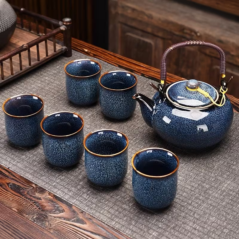 Japanese kiln-glazed porcelain tea set with six cups and teapot with filter in dark blue, featuring elegant traditional design.