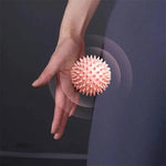Portable massage ball by TEMU, shown in black with textured surface for muscle relief and therapy.