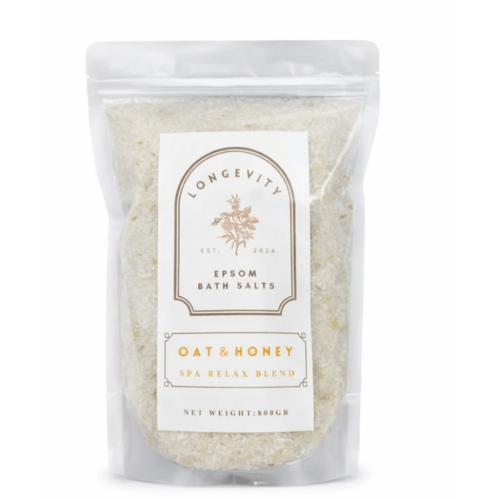 Green bath salt container labeled Longevity Oat & Honey Epsom Bath Salt by AW GIFTS, featuring natural ingredients and a calming spa design.