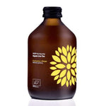 Herbalistas VIGO Kombucha tea with bio turmeric and ginger in a 330ml bottle, showcasing the brewed tea with fresh ingredients.