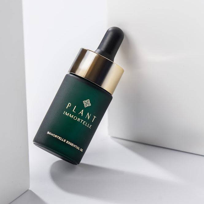 Bottle of Plant Immortelle essential oil for skin care by PLANT IMMORTELLE, showing a dark glass container with a dropper.