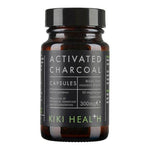 Kiki Health Activated Charcoal supplement in 50 vegetarian capsules, showing black capsules in a container.