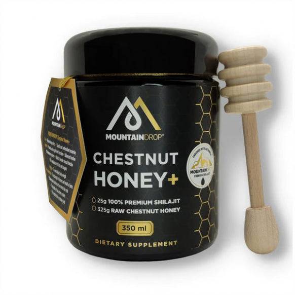 Spoonful of MountainDrop Shilajit and raw chestnut honey blend by Herbalistas in a glass jar with a wooden spoon.