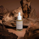 Rosemary hair and scalp strengthening oil by SELFNAMED, featuring a dropper bottle with fresh rosemary sprigs and herbal ingredients.