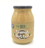 Creamy Green Life Cyprus peanut butter jar with a green label and spoonful of peanut butter showing its smooth texture.